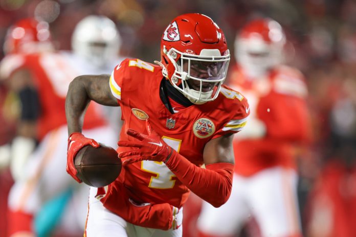 Kansas City Chiefs wide receiver Rashee Rice (4) runs after the catch for an 11-yard touchdown in the first quarter of an AFC Wild Card playoff game between the Miami Dolphins and Kansas City Chiefs on Jan 13, 2024 at GEHA Field at Arrowhead Stadium in Kansas City, MO.