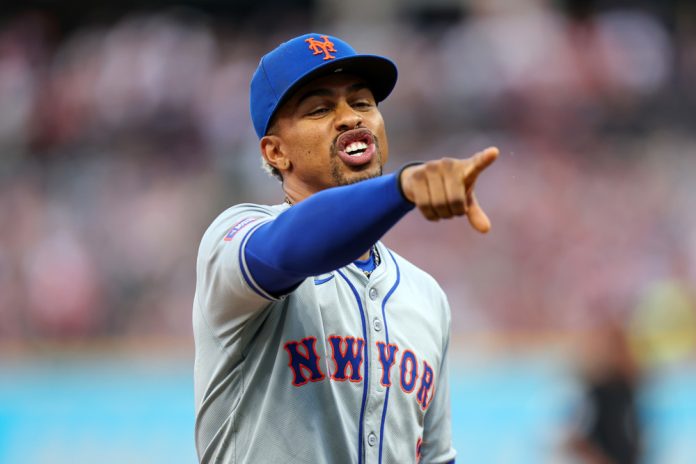 New York Mets shortstop Francisco Lindor (12) points into the Guardians dugout during a video review during the eighth inning of the Major League Baseball Interleague game between the New York Mets and Cleveland Guardians on May 20, 2024, at Progressive Field in Cleveland, OH.