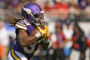 Minnesota Vikings running back Aaron Jones (33) runs with the ball during a NFL game between the Minnesota Vikings and Houston Texans on September 22, 2024, at U.S. Bank Stadium in Minneapolis, MN.