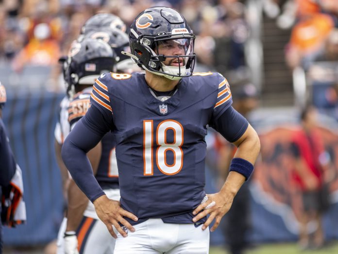 Chicago Bears quarterback Caleb Williams (18) looks over at the sidelines during a preseason game between the Cincinnati Bengals and the Chicago Bears on August 17, 2024, at Soldier Field in Chicago, Illinois.