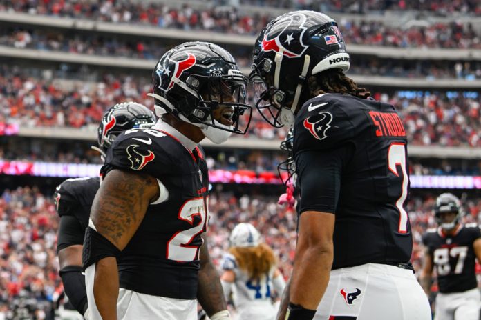 Houston Texans running back Joe Mixon (28) celebrates his first half rushing touchdown with Houston Texans quarterback C.J. Stroud (7) during the football game between the Indianapolis Colts and Houston Texans on October 27, 2024 at NRG Stadium in Houston, Texas.